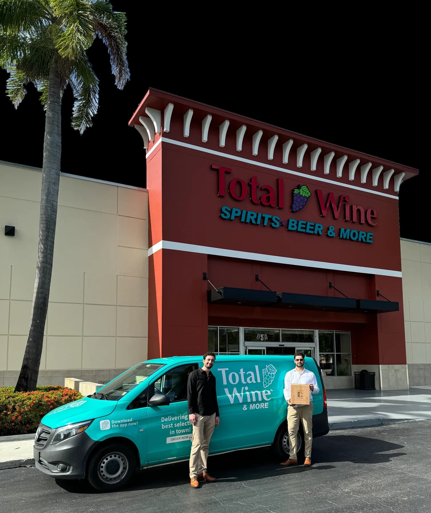 Two people beside a Total Wine & More delivery van outside the store, one holding a Lanchava Collection box